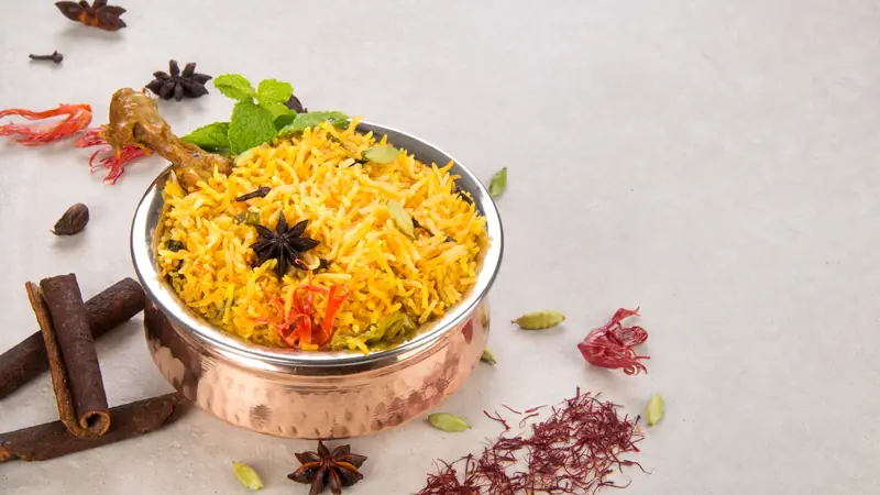 Chicken biryani served in a copper handi at Mustard Food Court, HSR Layout